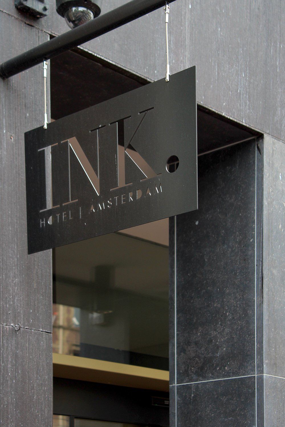 The entrance of the Ink Hotel Amsterdam on Nieuwezijds Voorburgwal