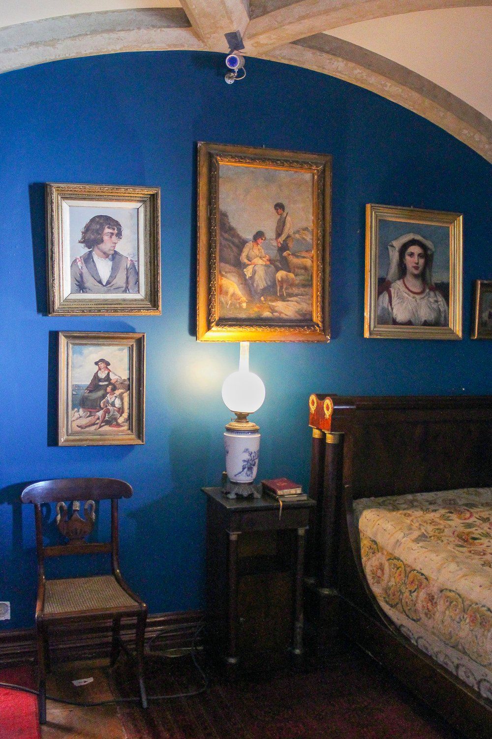 Blue bedroom with paintings