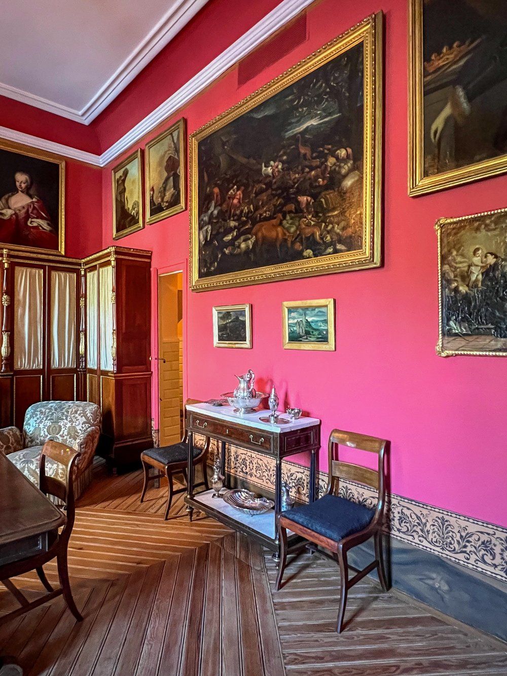Pink wall with antique furniture